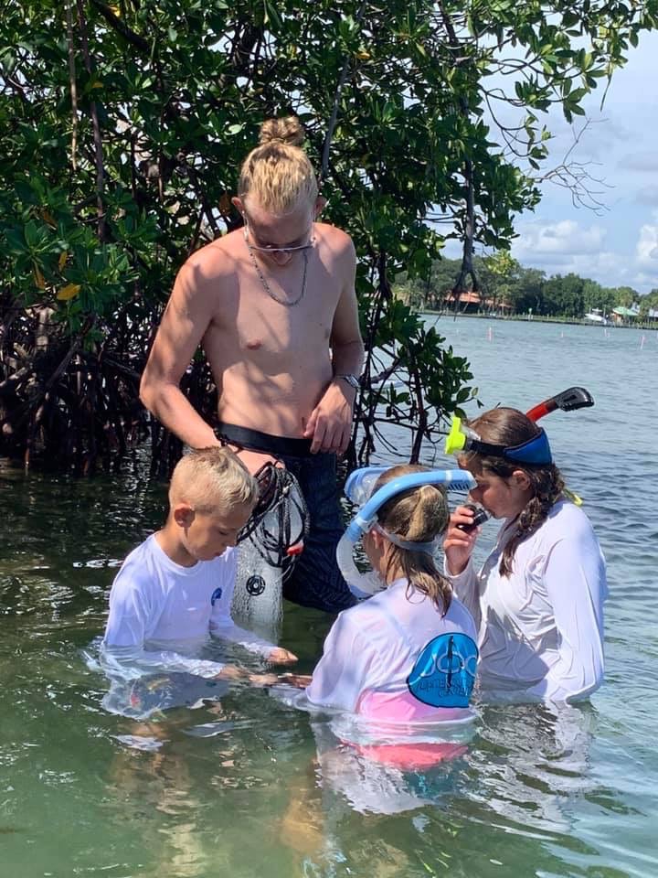 man and kids snorkeling