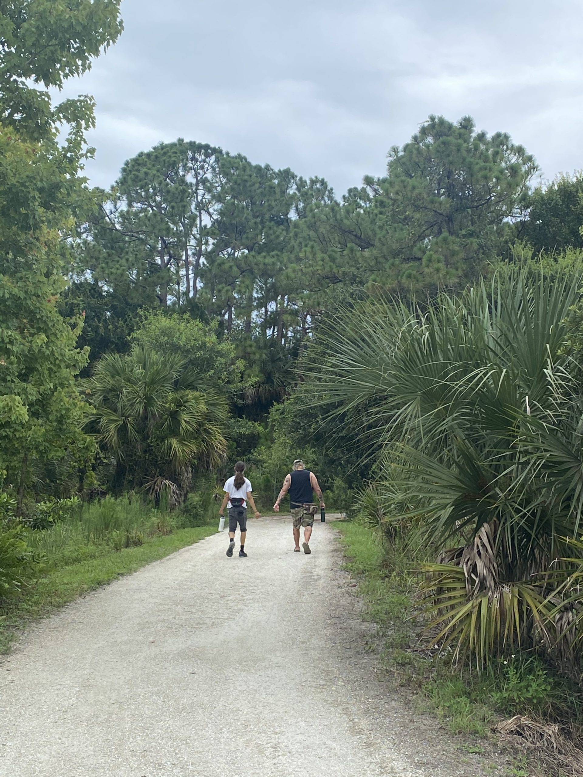 a man riding a bike down a dirt road